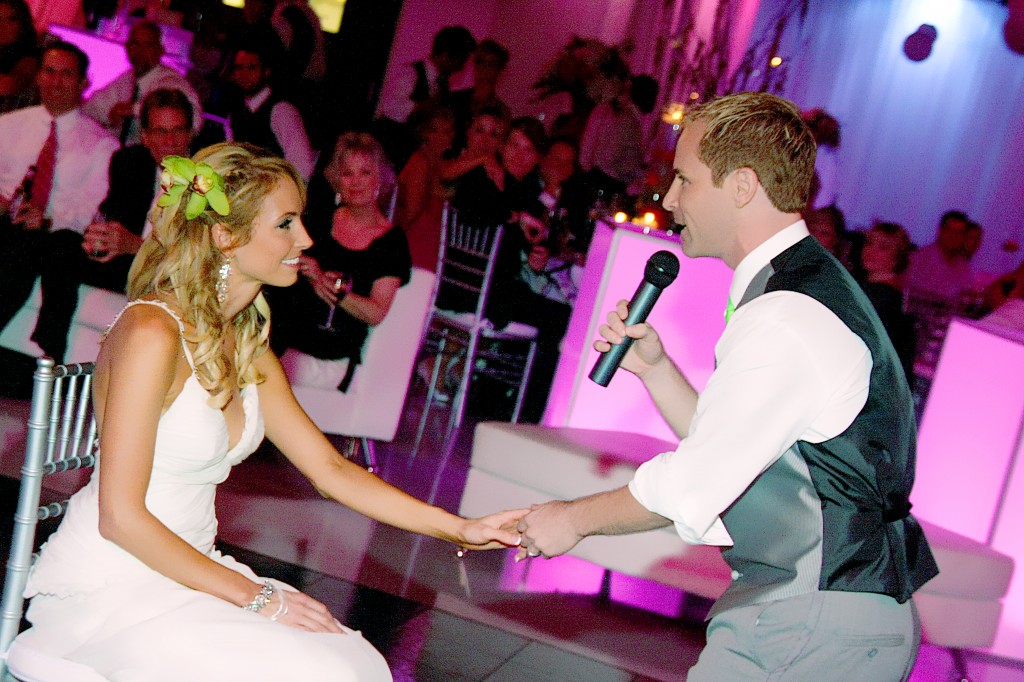 Groom sings to bride at wedding reception